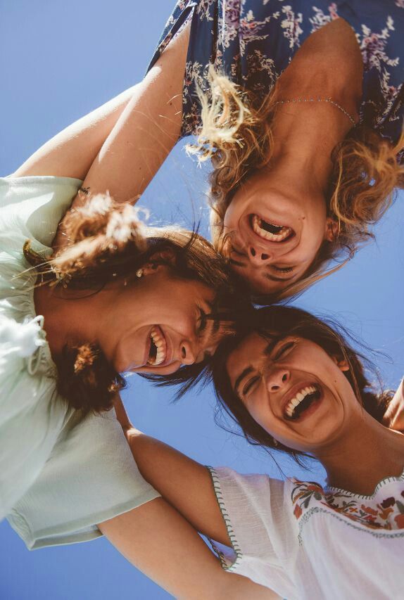 friends facing the ground with a blue sky above them