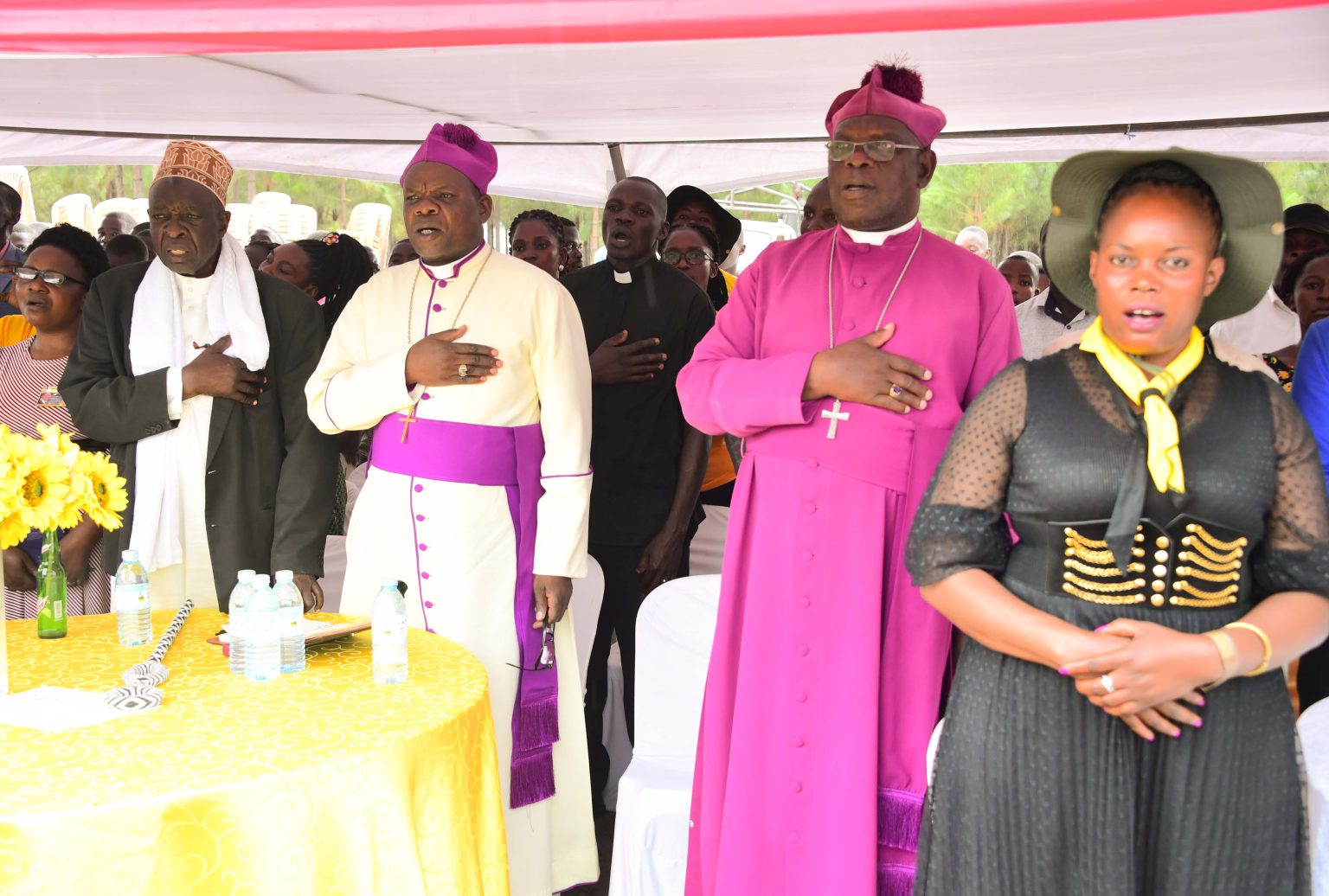 Ugandan Clergy in prayer under a tent