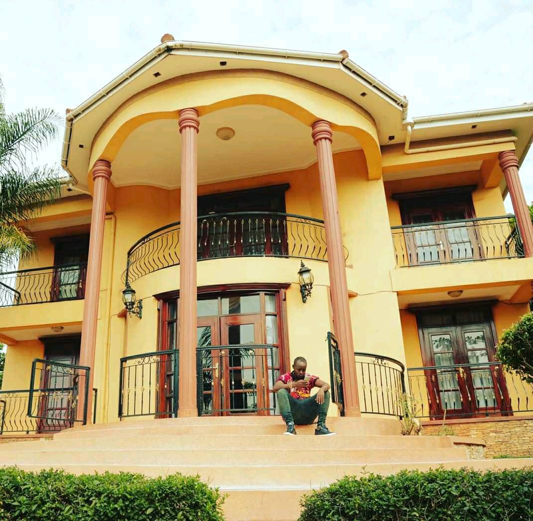 Eddy Kenzo sitting at the front stairs of his house (2016)