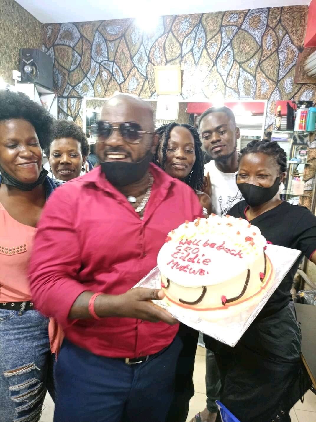 Eddie Mutwe receives cake from his Saloon Employees 