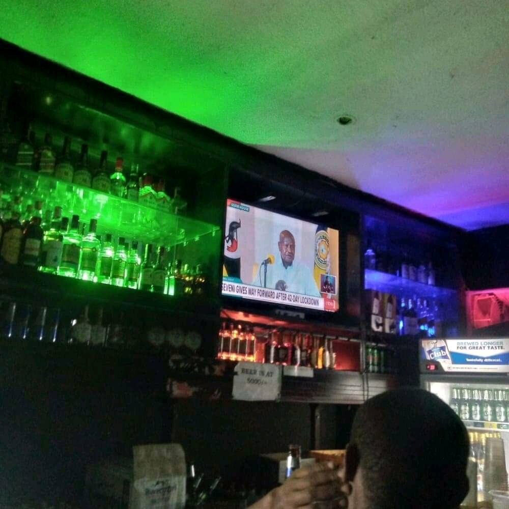 Ugandans watch presidential address in the bar