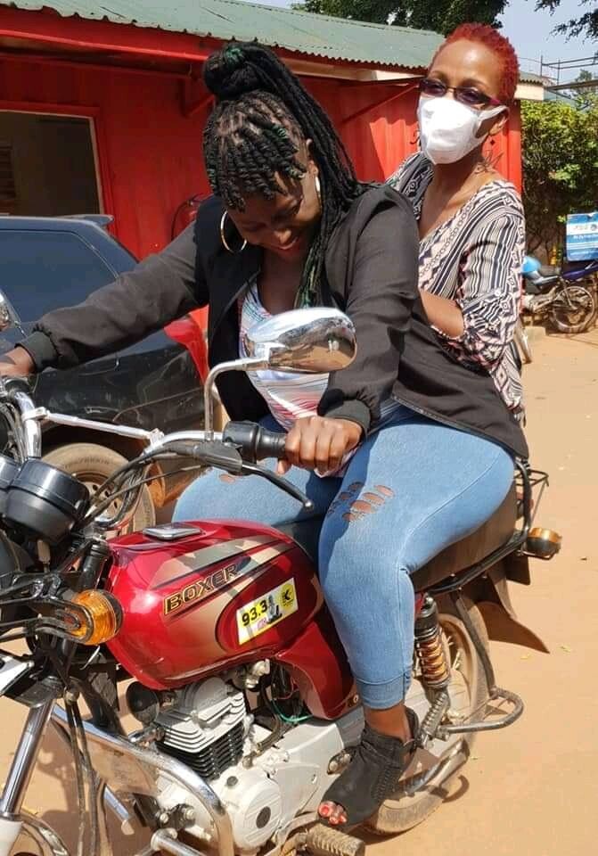 Radio presenters, Bina Baibe(behind) and Doreen Nasasira experimenting the one passenger per boda rule 