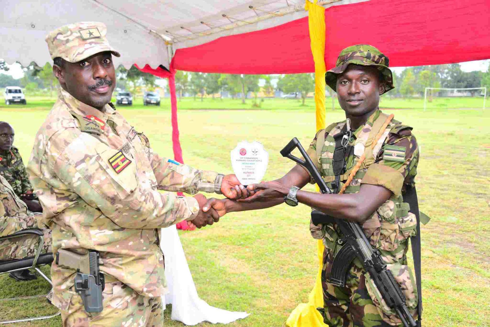 Two Ugandan soldiers sahking hands