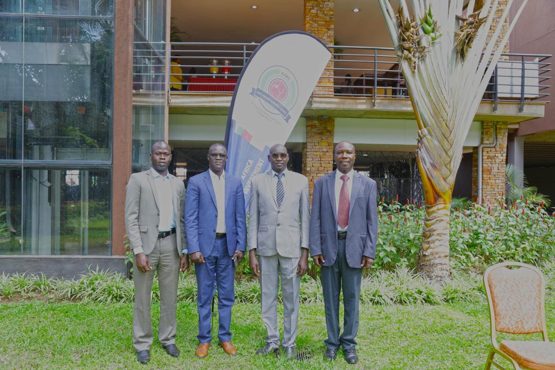 Men standing out of the conference room, dressed in suits