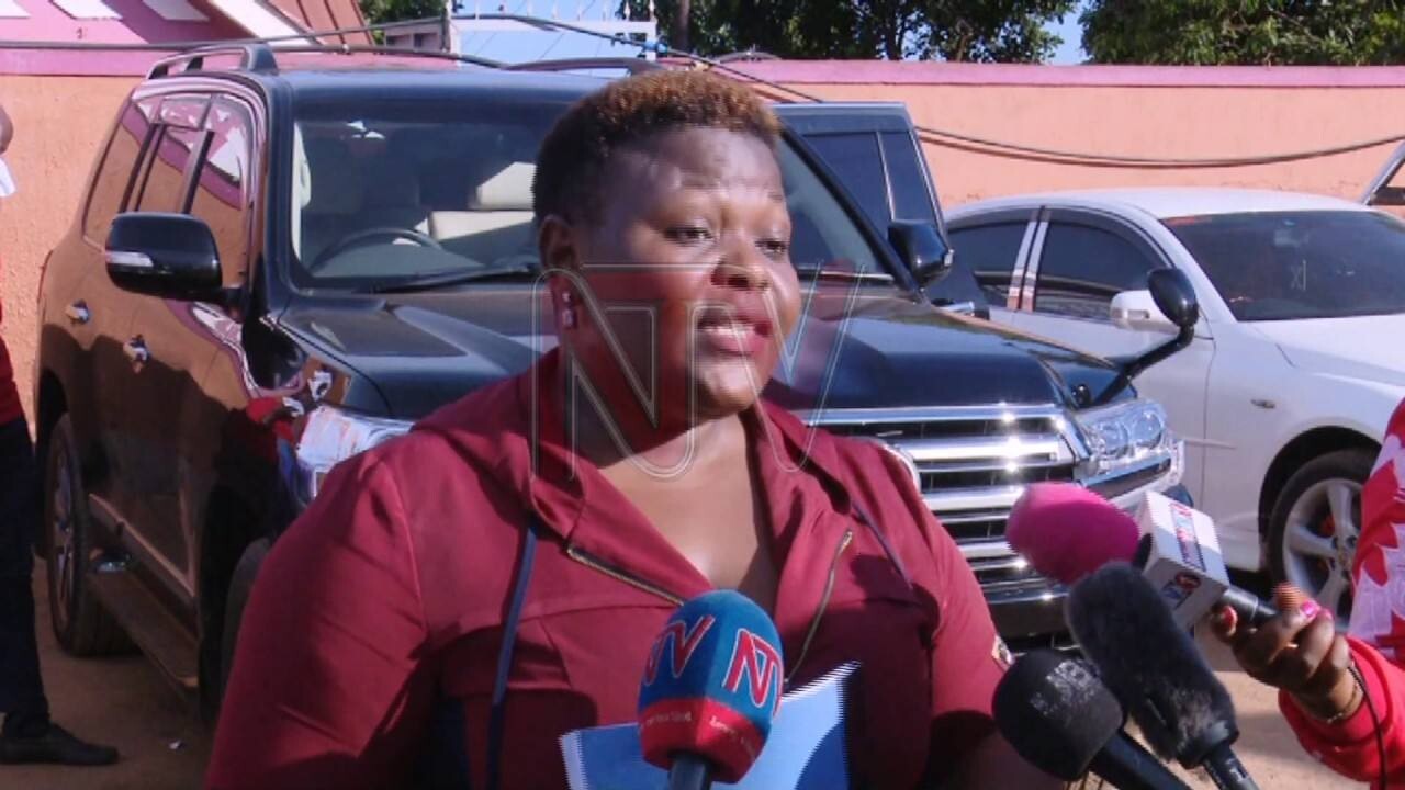 Catherine Kusasira with her monster car (in the background)